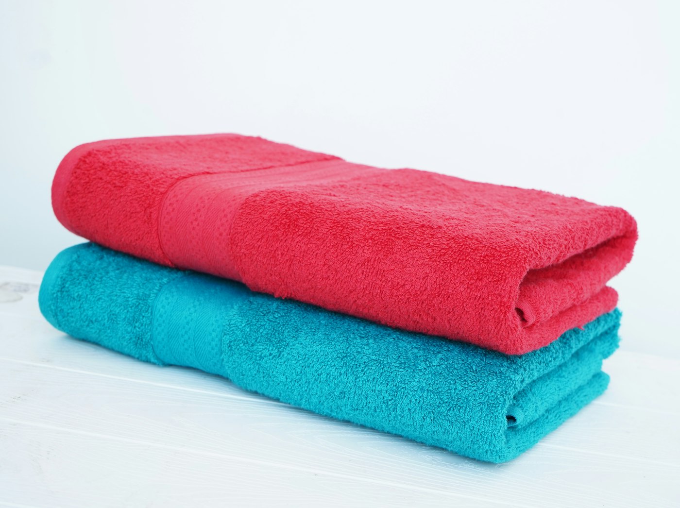 Red and turquoise folded bath towels